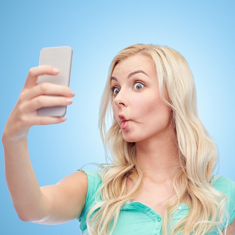 woman making duckface selfie